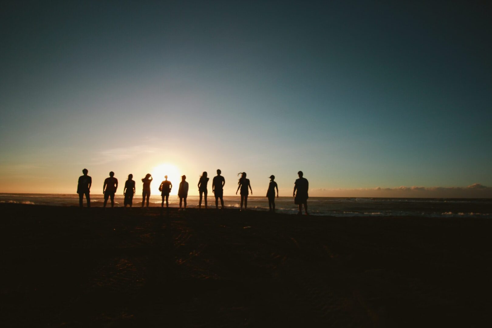 A group of people standing on top of a hill.